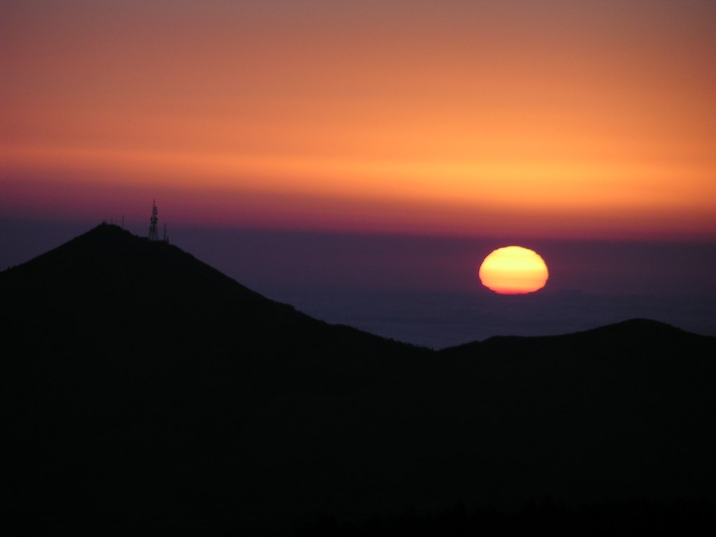 A deformed sun hovers over the Mediterranean Sea.