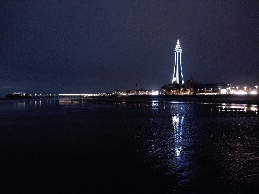 Blackpool tower and North Pier and lots of beach at night.