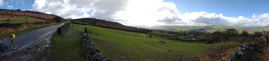 180 degree panorama of the Derwent valley above Curbar. It's raining on the left of the picture, the sun is shining brightly on the right.